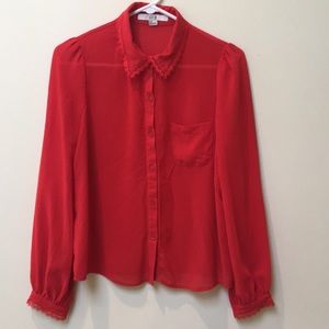 Deep red blouse with lace on collar and sleeves.